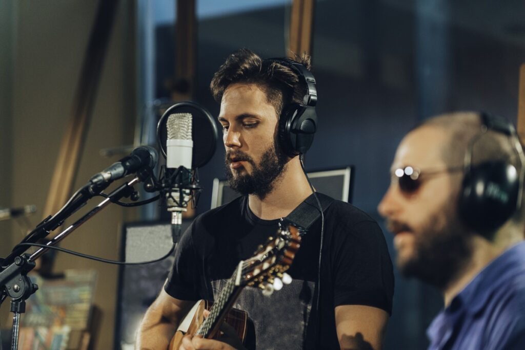 A band recording a song in the studio